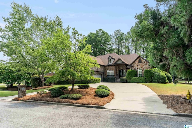 view of front of house with a front yard and a garage