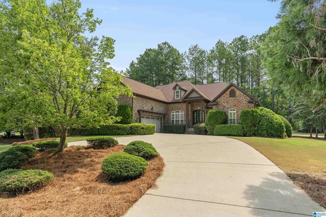 view of front of house with a front yard and a garage