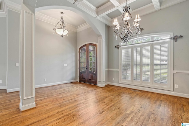 foyer with french doors, light hardwood / wood-style floors, coffered ceiling, and beam ceiling