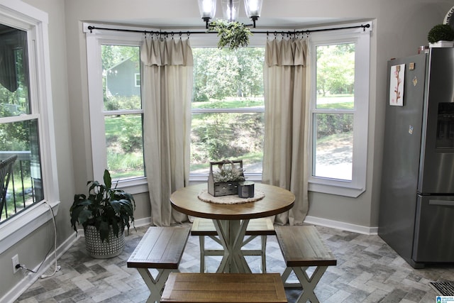 dining room featuring baseboards and a notable chandelier