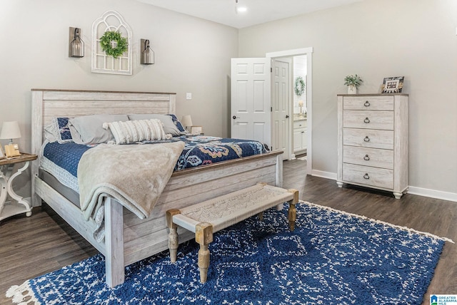 bedroom featuring dark wood finished floors and baseboards