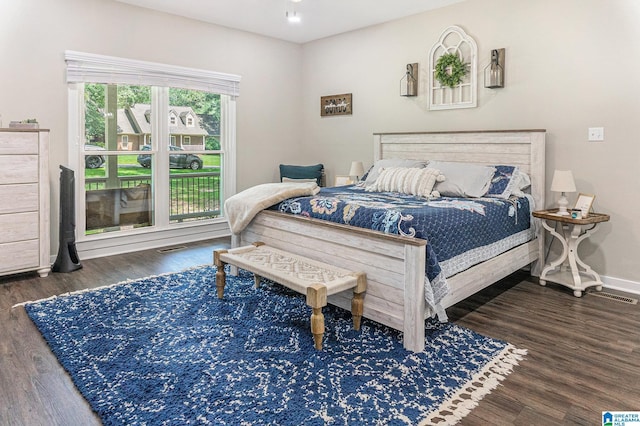 bedroom with visible vents, baseboards, and dark wood finished floors