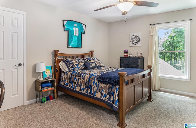 bedroom with light carpet, ceiling fan, and baseboards