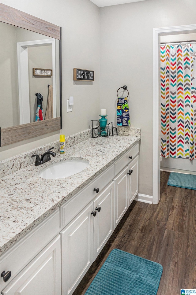 full bath with wood finished floors and vanity