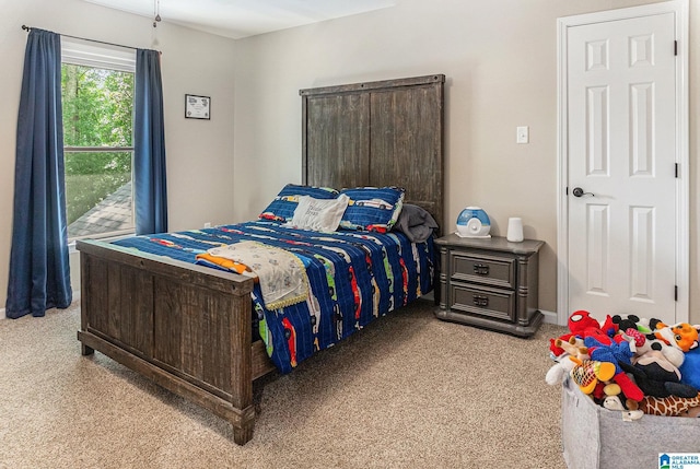 bedroom with light carpet and baseboards