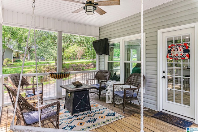 sunroom / solarium with plenty of natural light and a ceiling fan