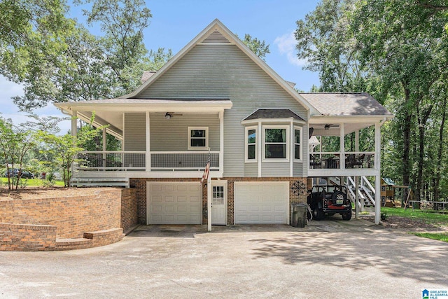 view of front of house with brick siding, a porch, concrete driveway, a garage, and stairs