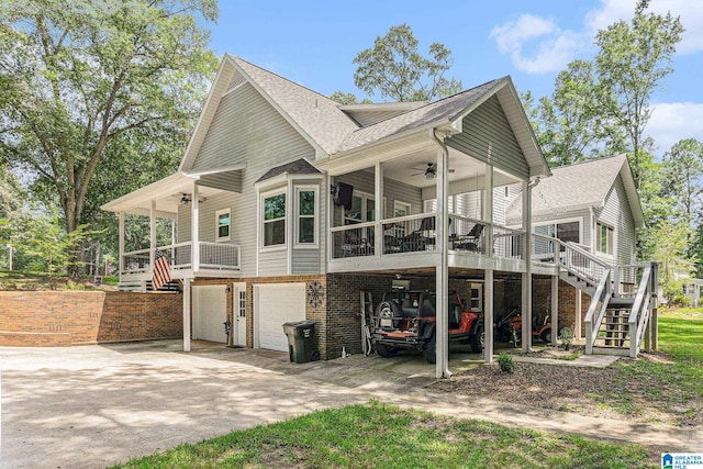 rear view of house featuring a carport, a porch, a garage, and ceiling fan