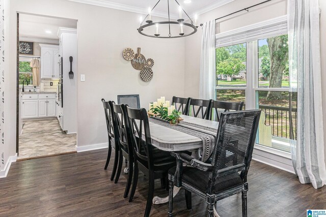 living room featuring dark hardwood / wood-style flooring, ceiling fan with notable chandelier, and crown molding