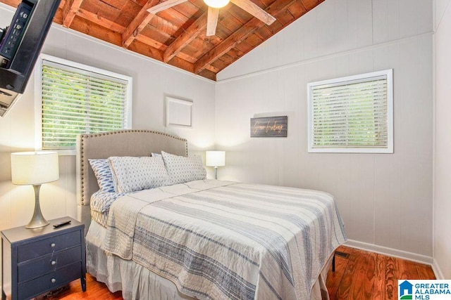 bedroom featuring lofted ceiling with beams, wooden ceiling, wood finished floors, and baseboards