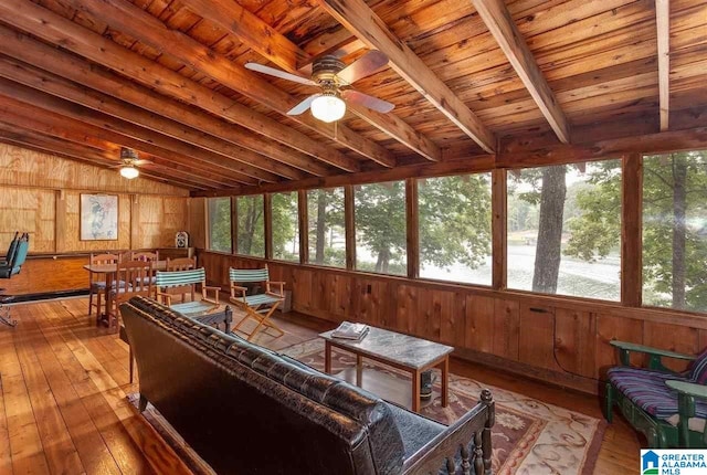 sunroom / solarium featuring vaulted ceiling with beams, plenty of natural light, and wood ceiling