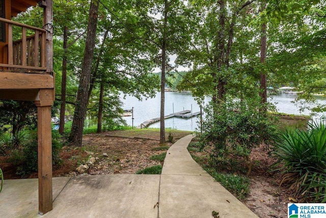 view of yard with a water view and a dock