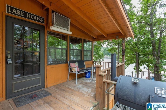 wooden deck featuring a grill