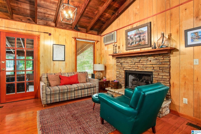 living area with visible vents, wooden ceiling, a wall unit AC, and wooden walls