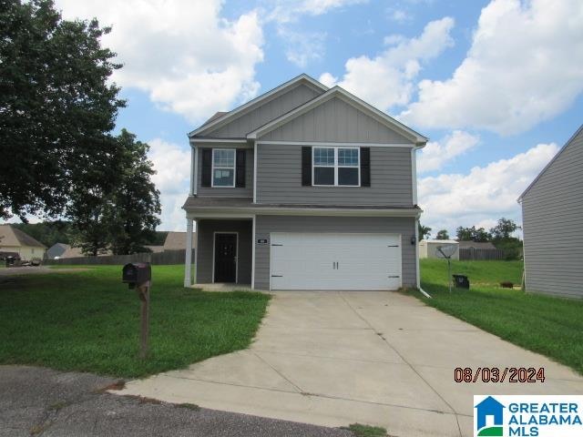 view of front of house with a garage and a front lawn