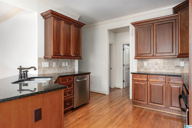 kitchen with dark stone counters, tasteful backsplash, sink, dishwasher, and light hardwood / wood-style flooring