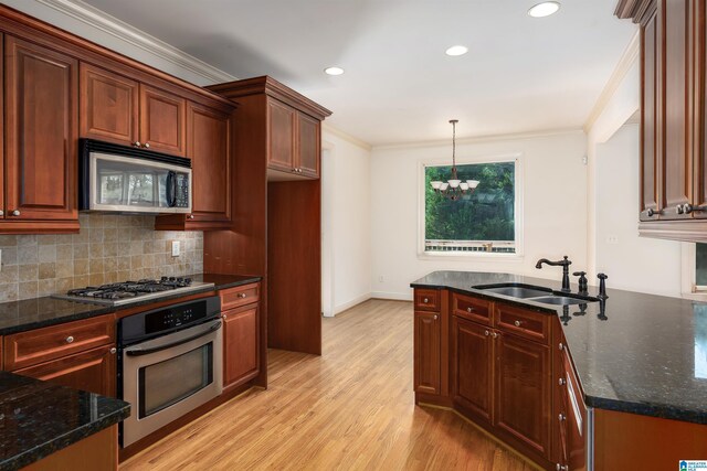 kitchen with decorative backsplash, light wood-type flooring, sink, dark stone countertops, and appliances with stainless steel finishes