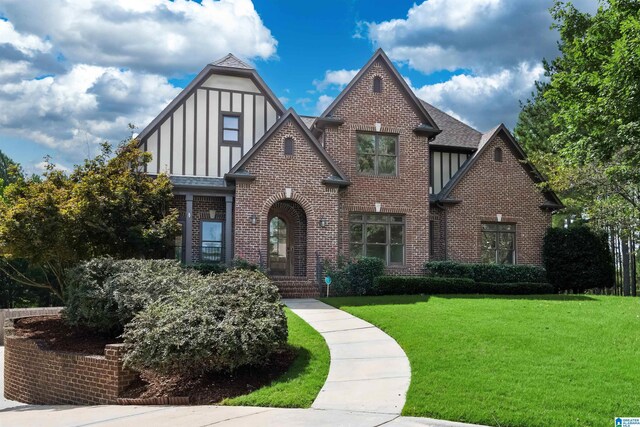 tudor home with a front yard