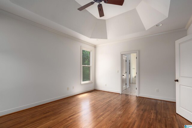 spare room with tile patterned flooring, a raised ceiling, ornamental molding, and ceiling fan