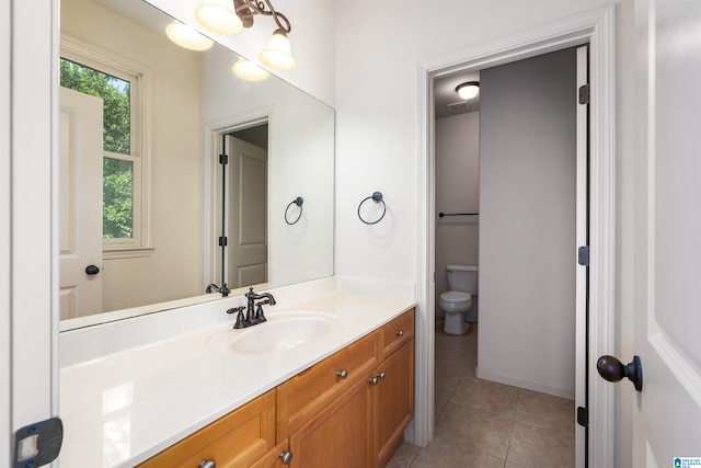 bathroom with tile patterned flooring, toilet, and vanity