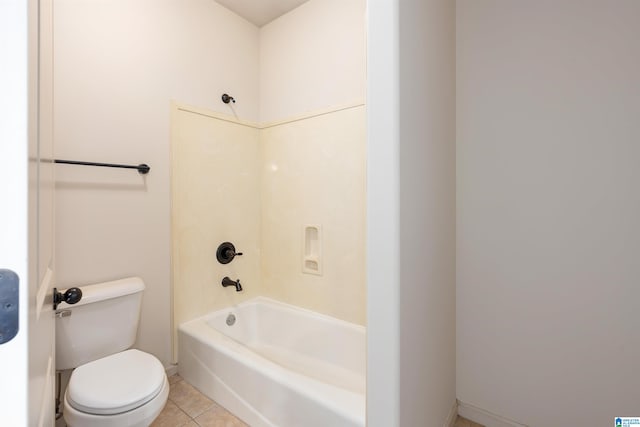 bathroom featuring tile patterned flooring, washtub / shower combination, and toilet