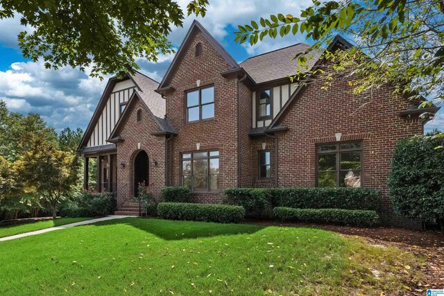 tudor home with a front yard