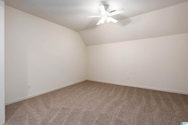 additional living space featuring carpet floors, ceiling fan, and vaulted ceiling