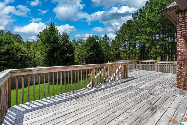 wooden deck with a lawn