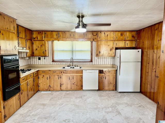 kitchen featuring a warming drawer, light countertops, a sink, white appliances, and under cabinet range hood