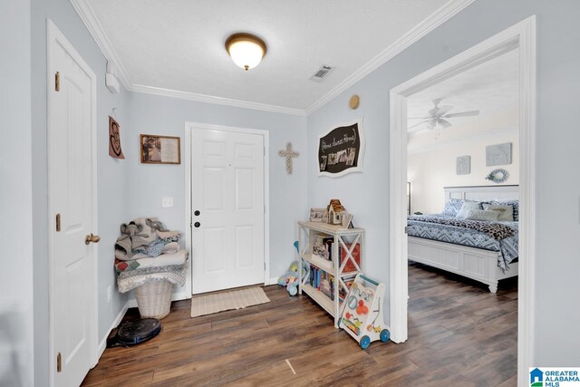 foyer entrance with ceiling fan, dark hardwood / wood-style flooring, and ornamental molding