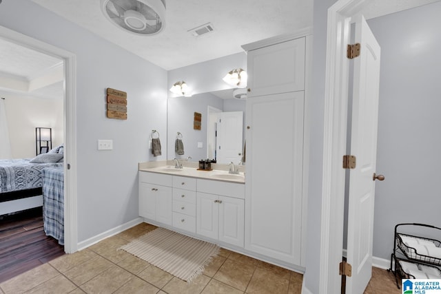 bathroom featuring tile patterned floors and double sink vanity