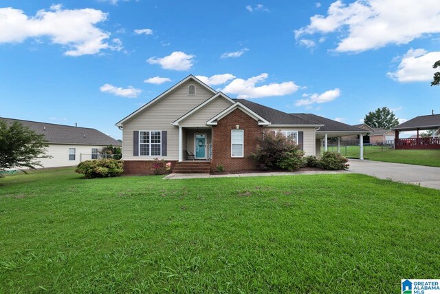 view of front of home with a front yard and a carport