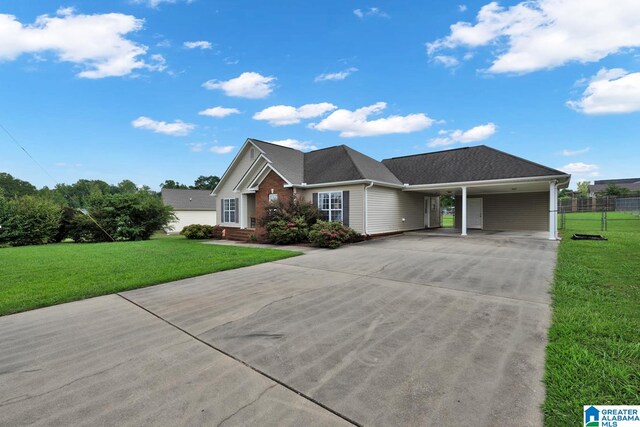 view of front facade with a front yard and a carport