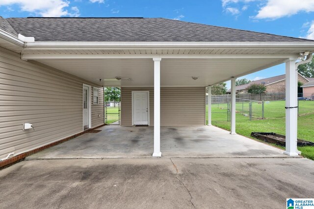 view of car parking with a yard and a carport