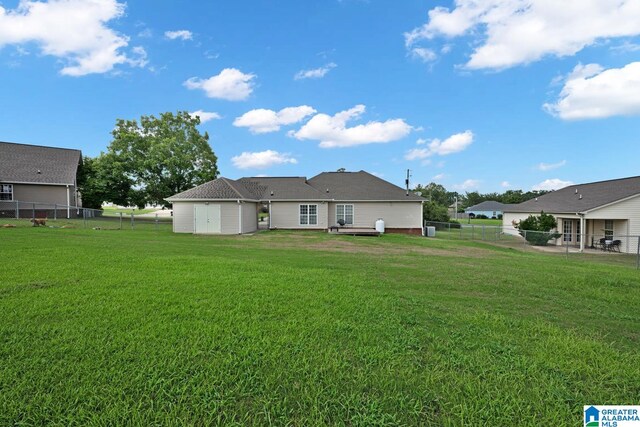 back of property featuring a lawn