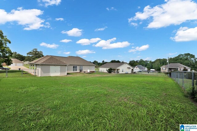 view of yard with a garage and an outdoor structure