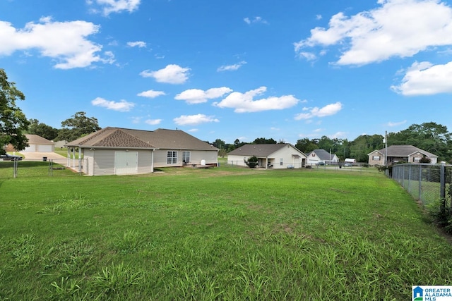 view of yard with a garage and an outbuilding