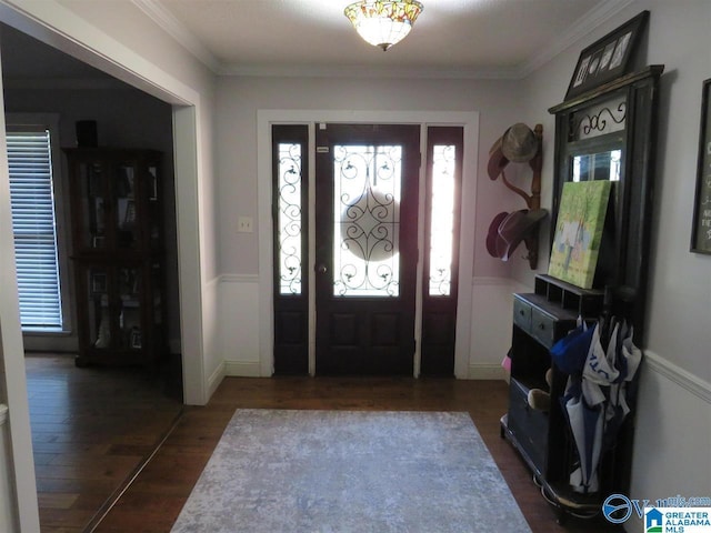 foyer entrance with dark wood-type flooring and ornamental molding