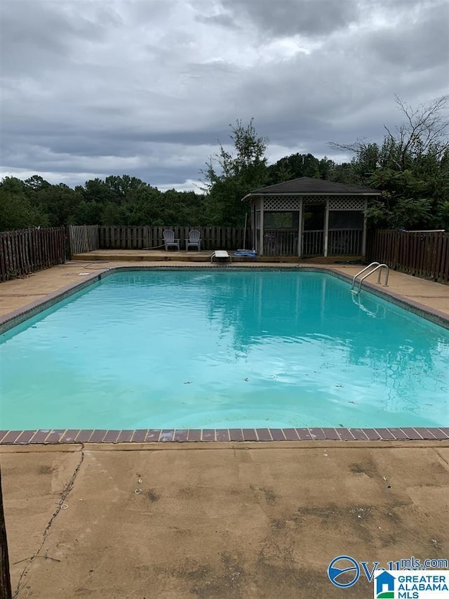 view of swimming pool with a gazebo and a patio