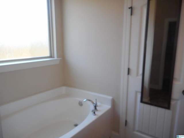 bathroom with a tub to relax in