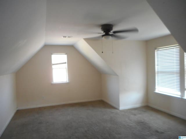 bonus room with carpet flooring, lofted ceiling, and ceiling fan