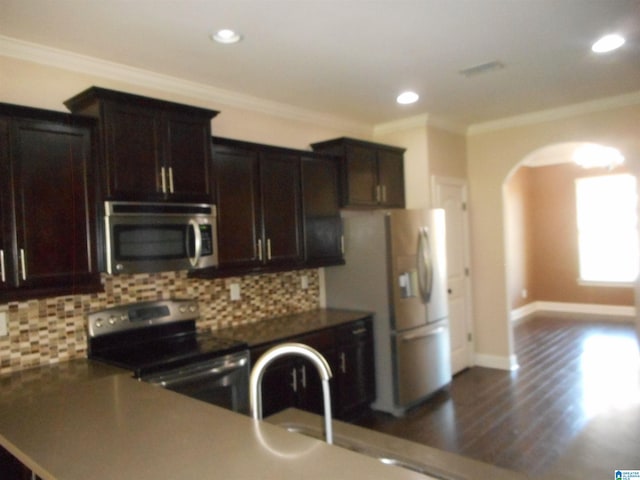 kitchen with dark hardwood / wood-style flooring, white refrigerator, tasteful backsplash, and stove