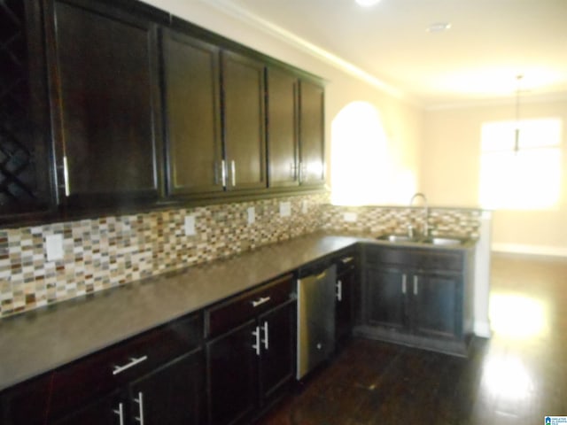 kitchen with dishwasher, tasteful backsplash, sink, and ornamental molding