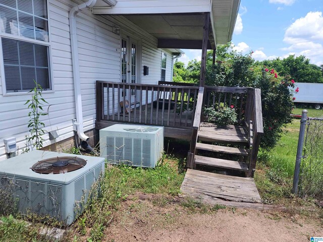 wooden deck featuring central AC and a fire pit