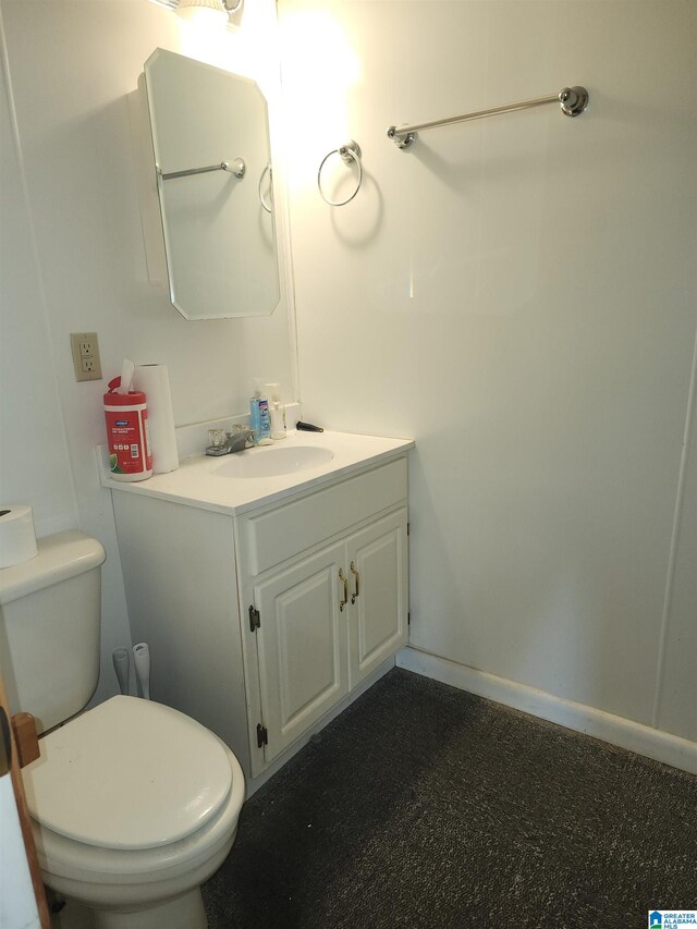 bathroom featuring toilet and vanity