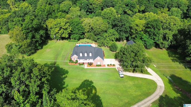 birds eye view of property with a forest view