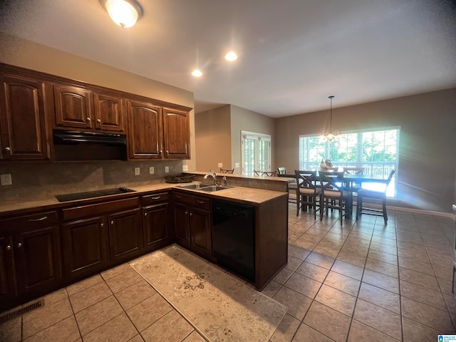 kitchen featuring black appliances, dark brown cabinets, kitchen peninsula, decorative light fixtures, and a notable chandelier