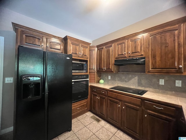 kitchen featuring decorative backsplash, extractor fan, black appliances, and light tile patterned floors