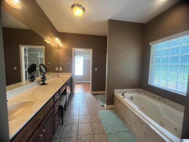 bathroom featuring dual vanity, plenty of natural light, and tile patterned floors