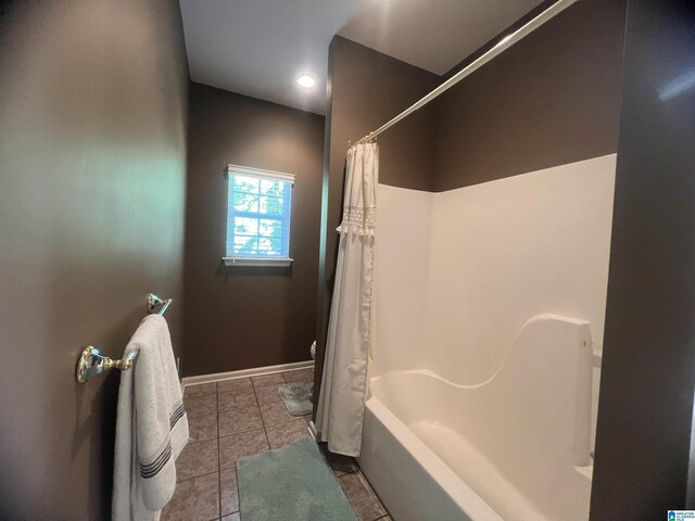 bathroom featuring shower / bath combo with shower curtain and tile patterned floors